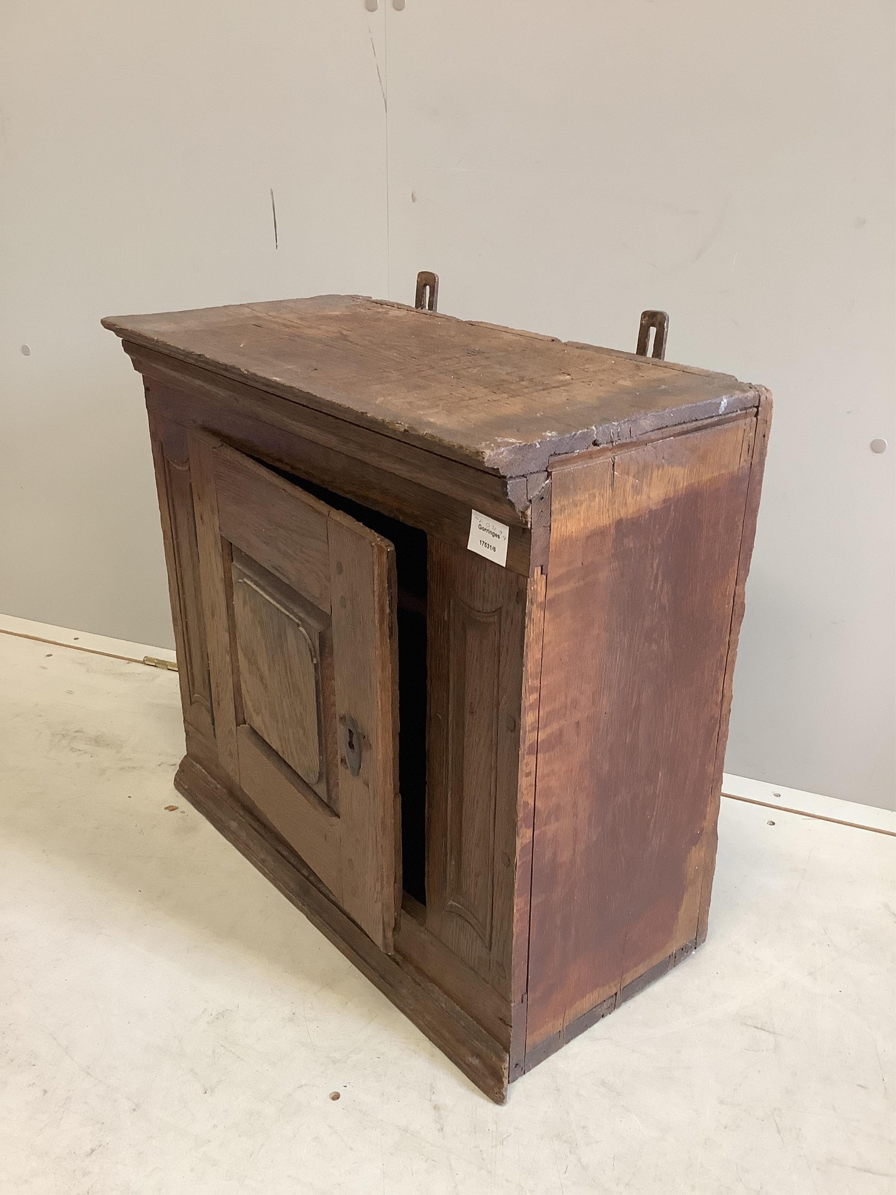 A small oak cupboard, width 61cm, depth 32cm, height 58cm